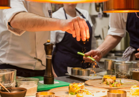 Chef plating gourmet dish — kitchen and chef positions in Dallas